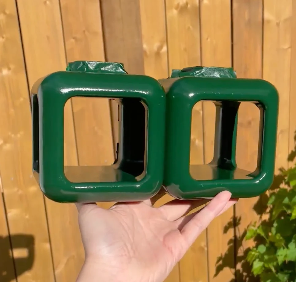 Two cube sections primed and painted glossy green, held in one hand
